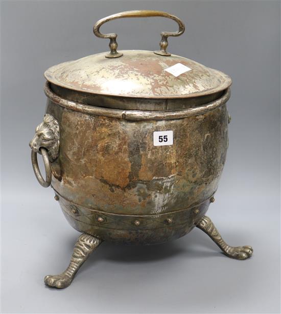 A silvered copper lidded coal scuttle, paw feet and lion handles height 43cm